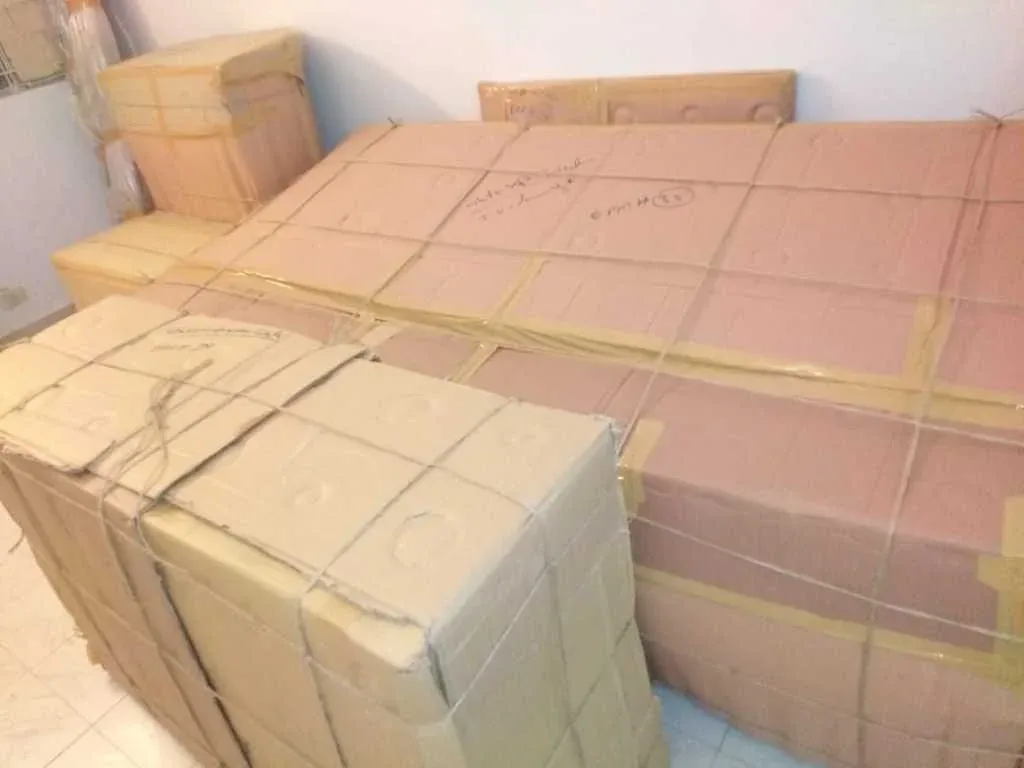 Packed and wrapped furniture stacked for transport to another city